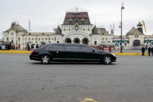 A black limousine parked in front of a large building, indicating a limo rental near Newark NJ