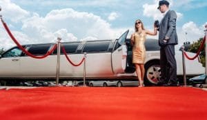 A stylish limousine featuring floral arrangements on the back, representing Anniversary Limo Rental Services.