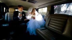 A luxurious limousine adorned with flowers on the rear, showcasing Anniversary Limo Rental Services. 