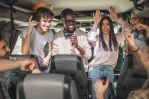 A group of friends enjoying a lively moment together on a party bus, celebrating and having fun.