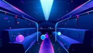 Dark blue party bus interior adorned with colorful balloons and vibrant neon lights, creating a festive atmosphere.